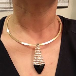 Gold Metal choker with rhinestone pendant.